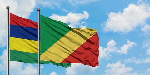 Mauritius and Republic Of The Congo flag waving in the wind against white cloudy blue sky together. Diplomacy concept, international relations.