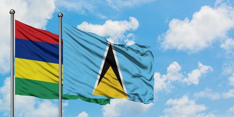 Mauritius and Saint Lucia flag waving in the wind against white cloudy blue sky together. Diplomacy concept, international relations.