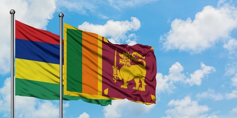 Mauritius and Sri Lanka flag waving in the wind against white cloudy blue sky together. Diplomacy concept, international relations.