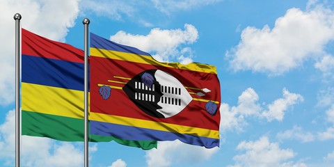 Mauritius and Swaziland flag waving in the wind against white cloudy blue sky together. Diplomacy concept, international relations.