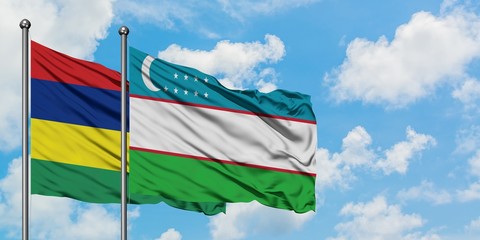 Mauritius and Uzbekistan flag waving in the wind against white cloudy blue sky together. Diplomacy concept, international relations.