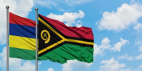 Mauritius and Vanuatu flag waving in the wind against white cloudy blue sky together. Diplomacy concept, international relations.