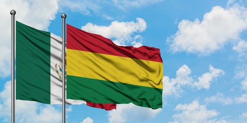 Mexico and Bolivia flag waving in the wind against white cloudy blue sky together. Diplomacy concept, international relations.