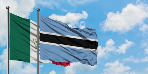 Mexico and Botswana flag waving in the wind against white cloudy blue sky together. Diplomacy concept, international relations.