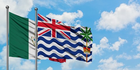 Mexico and British Indian Ocean Territory flag waving in the wind against white cloudy blue sky together. Diplomacy concept, international relations.