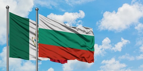 Mexico and Bulgaria flag waving in the wind against white cloudy blue sky together. Diplomacy concept, international relations.