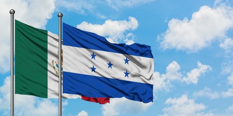 Mexico and Honduras flag waving in the wind against white cloudy blue sky together. Diplomacy concept, international relations.