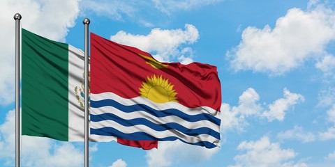 Mexico and Kiribati flag waving in the wind against white cloudy blue sky together. Diplomacy concept, international relations.