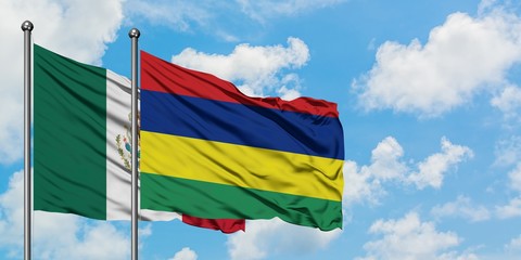 Mexico and Mauritius flag waving in the wind against white cloudy blue sky together. Diplomacy concept, international relations.