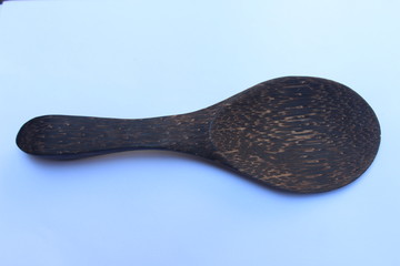 Abtract wooden texture large rice ladle on white background - image
