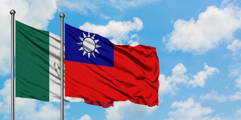 Mexico and Taiwan flag waving in the wind against white cloudy blue sky together. Diplomacy concept, international relations.