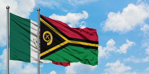 Mexico and Vanuatu flag waving in the wind against white cloudy blue sky together. Diplomacy concept, international relations.