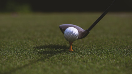 golf club and golf ball close up in grass field with sunset. Golf ball close up in golf coures at Thailand