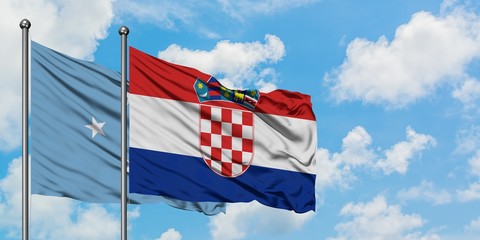 Micronesia and Croatia flag waving in the wind against white cloudy blue sky together. Diplomacy concept, international relations.