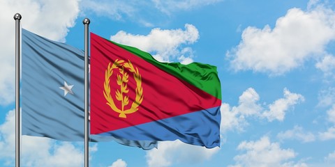Micronesia and Eritrea flag waving in the wind against white cloudy blue sky together. Diplomacy concept, international relations.