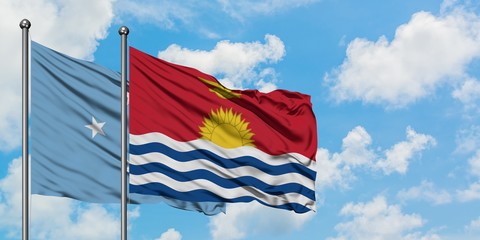 Micronesia and Kiribati flag waving in the wind against white cloudy blue sky together. Diplomacy concept, international relations.