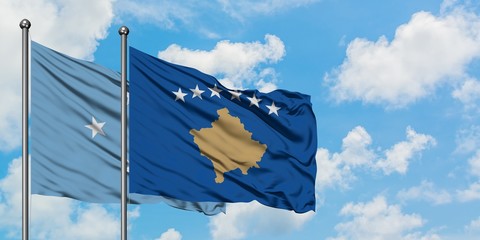 Micronesia and Kosovo flag waving in the wind against white cloudy blue sky together. Diplomacy concept, international relations.