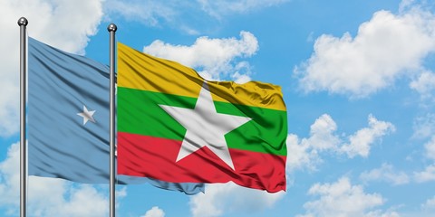 Micronesia and Myanmar flag waving in the wind against white cloudy blue sky together. Diplomacy concept, international relations.