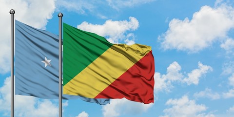 Micronesia and Republic Of The Congo flag waving in the wind against white cloudy blue sky together. Diplomacy concept, international relations.