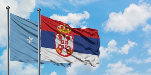 Micronesia and Serbia flag waving in the wind against white cloudy blue sky together. Diplomacy concept, international relations.