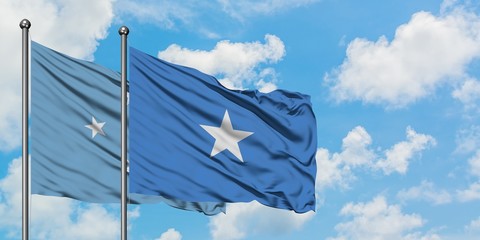 Micronesia and Somalia flag waving in the wind against white cloudy blue sky together. Diplomacy concept, international relations.