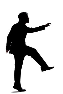 recommend clip art: Silhouette of a backlit model posing as a businessman on a white background.  He is jumping up or leaping forward.