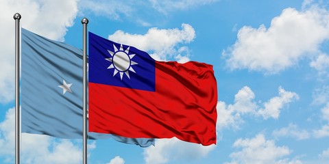 Micronesia and Taiwan flag waving in the wind against white cloudy blue sky together. Diplomacy concept, international relations.