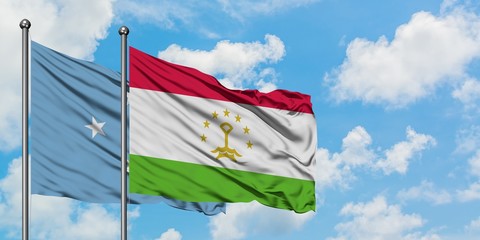 Micronesia and Tajikistan flag waving in the wind against white cloudy blue sky together. Diplomacy concept, international relations.