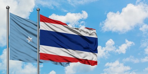 Micronesia and Thailand flag waving in the wind against white cloudy blue sky together. Diplomacy concept, international relations.