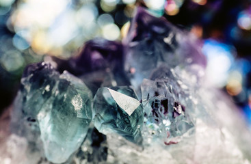 Geology of beauty. Natural cosmic wild jewels. Texture of gemstone lilac Fluorite closeup as a part of cluster geode filled with rock Quartz crystals.