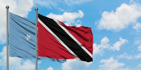 Micronesia and Trinidad And Tobago flag waving in the wind against white cloudy blue sky together. Diplomacy concept, international relations.