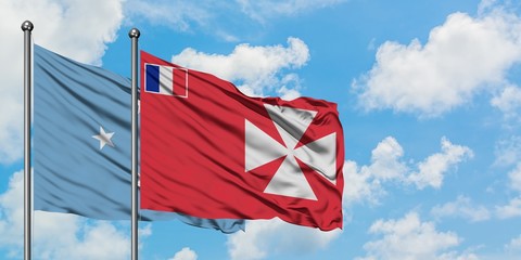 Micronesia and Wallis And Futuna flag waving in the wind against white cloudy blue sky together. Diplomacy concept, international relations.