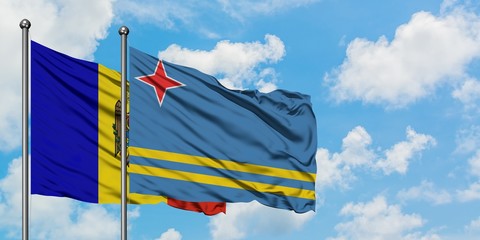 Moldova and Aruba flag waving in the wind against white cloudy blue sky together. Diplomacy concept, international relations.