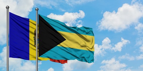 Moldova and Bahamas flag waving in the wind against white cloudy blue sky together. Diplomacy concept, international relations.