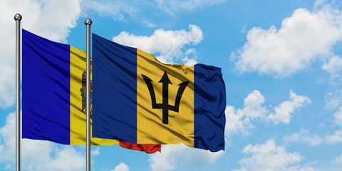 Moldova and Barbados flag waving in the wind against white cloudy blue sky together. Diplomacy concept, international relations.