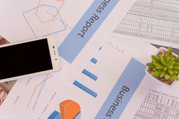 Text Business Report graph on paper with mobile calculator  on paper chat  background