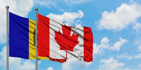 Moldova and Canada flag waving in the wind against white cloudy blue sky together. Diplomacy concept, international relations.