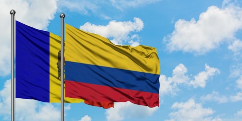 Moldova and Colombia flag waving in the wind against white cloudy blue sky together. Diplomacy concept, international relations.