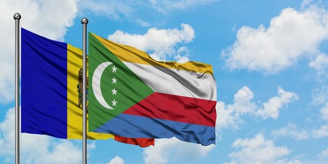 Moldova and Comoros flag waving in the wind against white cloudy blue sky together. Diplomacy concept, international relations.