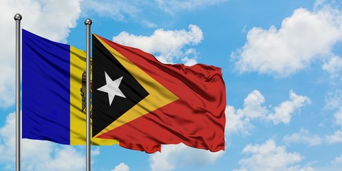 Moldova and East Timor flag waving in the wind against white cloudy blue sky together. Diplomacy concept, international relations.