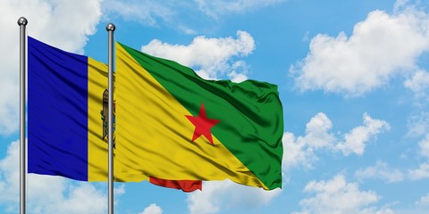 Moldova and French Guiana flag waving in the wind against white cloudy blue sky together. Diplomacy concept, international relations.