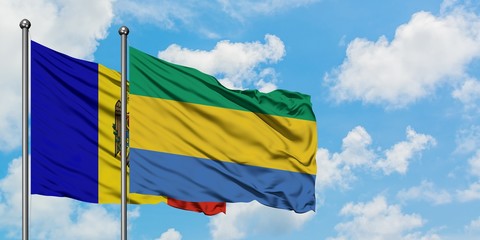Moldova and Gabon flag waving in the wind against white cloudy blue sky together. Diplomacy concept, international relations.