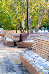 outdoor park benches coverd in snow and ice after autumn snowstorms