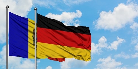 Moldova and Germany flag waving in the wind against white cloudy blue sky together. Diplomacy concept, international relations.