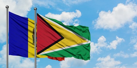 Moldova and Guyana flag waving in the wind against white cloudy blue sky together. Diplomacy concept, international relations.