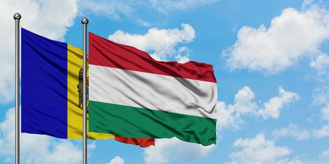 Moldova and Hungary flag waving in the wind against white cloudy blue sky together. Diplomacy concept, international relations.