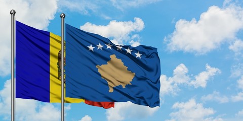 Moldova and Kosovo flag waving in the wind against white cloudy blue sky together. Diplomacy concept, international relations.