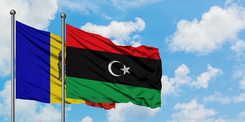 Moldova and Libya flag waving in the wind against white cloudy blue sky together. Diplomacy concept, international relations.
