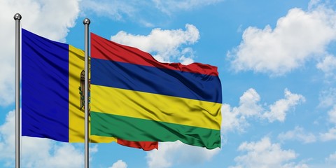 Moldova and Mauritius flag waving in the wind against white cloudy blue sky together. Diplomacy concept, international relations.