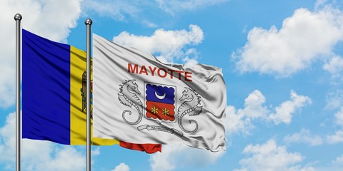Moldova and Mayotte flag waving in the wind against white cloudy blue sky together. Diplomacy concept, international relations.
